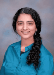 Woman with dark hair and a teal shirt